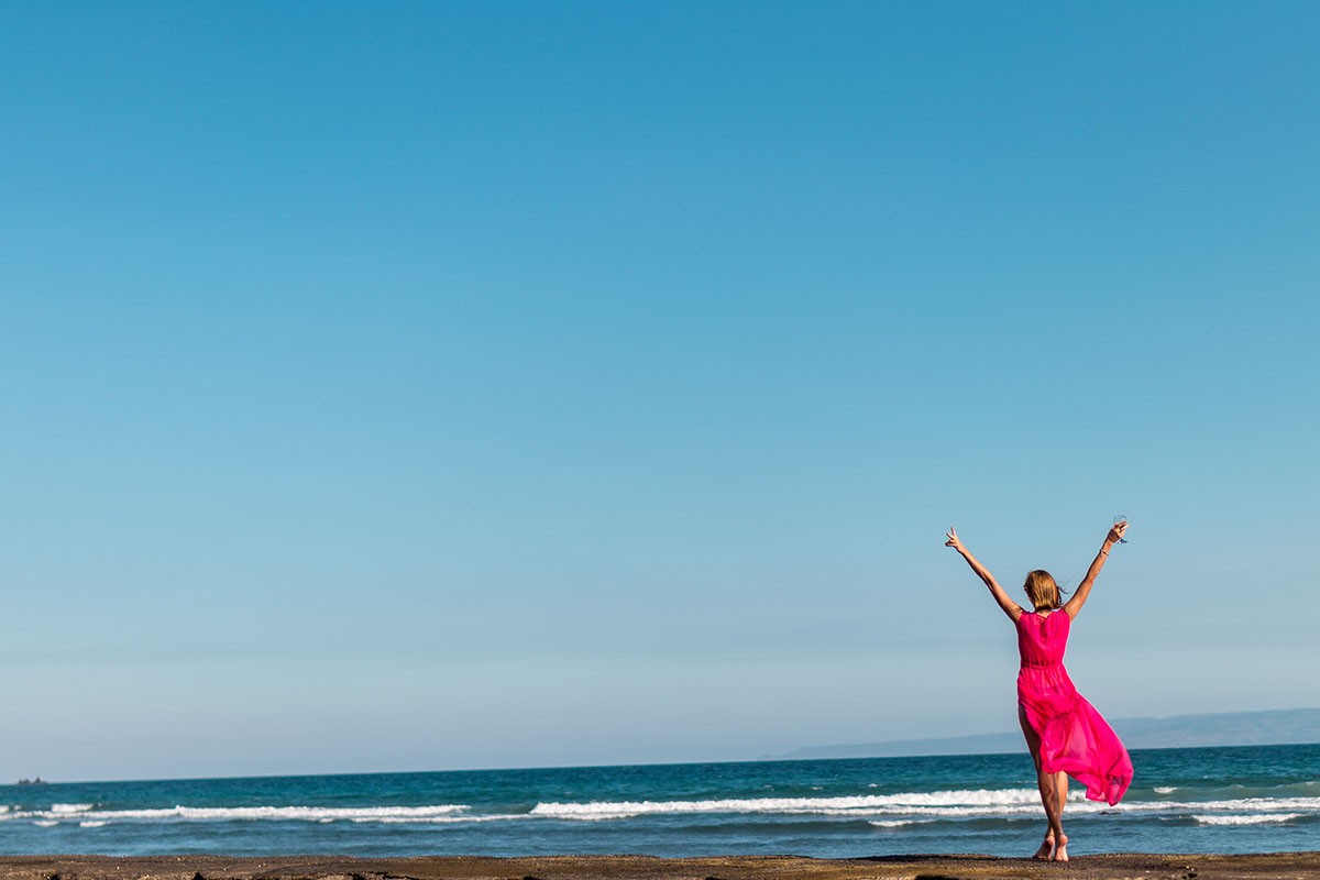 Girl on beach in pink dress